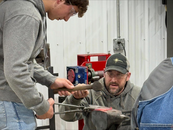 Handcrafted hook being forged during forging class at Heritage Designs